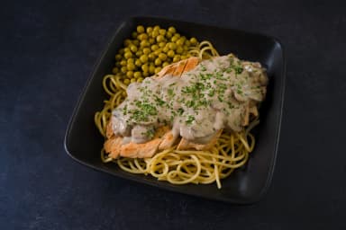 Chicken in mushroom sauce with spaghetti and peas